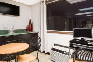 A television and/or entertainment centre at Super 8 by Wyndham Greensboro