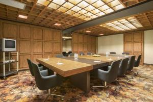 a large conference room with a large wooden table and chairs at Travelodge by Wyndham Edmonton East in Edmonton