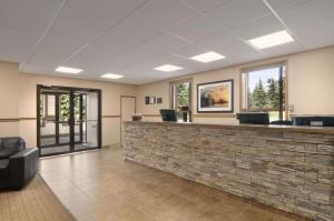 a waiting room with a stone counter and windows at BA Hotel in Red Deer