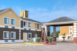 a hotel with a building with a clock tower at Super 8 by Wyndham Victoria/North/Mall Area in Victoria