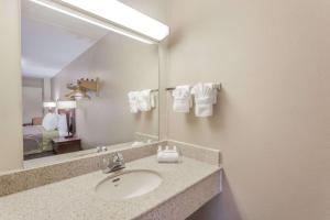a bathroom with a sink and a mirror at Super 8 by Wyndham Manassas in Manassas