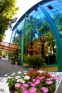 a building with a bunch of flowers in front of it at Hotel Michelangelo in Forlì