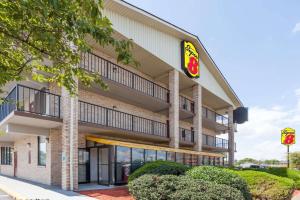 an exterior view of a building with a restaurant at Super 8 by Wyndham Manassas in Manassas