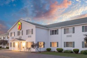 a large white building with a fast food restaurant at Super 8 by Wyndham Canandaigua in Canandaigua