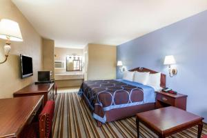 een hotelkamer met een bed en een bureau bij Super 8 by Wyndham Mt. Pleasant TX in Mount Pleasant