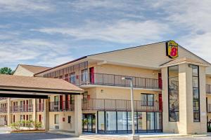 a hotel with a sign on the front of it at Super 8 by Wyndham Fredericksburg in Fredericksburg