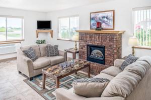 a living room with couches and a fireplace at Super 8 by Wyndham Nebraska City in Percival
