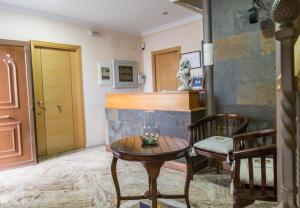 uma sala de estar com uma mesa e uma cadeira em La Posada De Sancho em Tomelloso