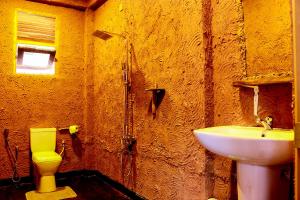 a bathroom with a sink and a toilet at Bundala Flamingo Cotteges in Hambantota