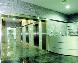 a lobby with green marble walls and a counter at Warsaw Apartments Werset in Warsaw