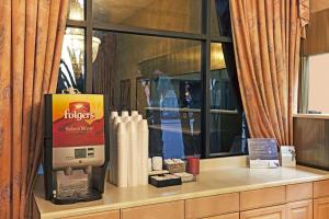 a coffee machine sitting on a counter in front of a window at Buena Park Inn in Anaheim