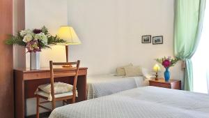 Postel nebo postele na pokoji v ubytování Hotel Villa Augustus