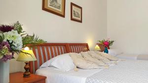 Postel nebo postele na pokoji v ubytování Hotel Villa Augustus