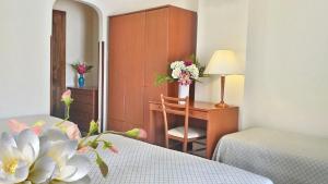 Postel nebo postele na pokoji v ubytování Hotel Villa Augustus