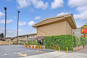 a front view of a hotel with a parking lot at Super 8 by Wyndham Los Angeles-Culver City Area in Los Angeles