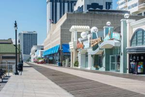 a boardwalk in a city with shops and buildings at Atlantic Motor Inn Near Boardwalk in Atlantic City