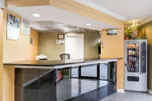 a bar in a hospital room with a refrigerator at Super 8 by Wyndham Indianapolis-Southport Rd in Indianapolis