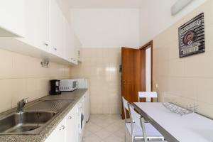 a kitchen with a sink and a counter at Sunrise Apartment I in Carvoeiro