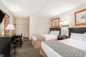 a hotel room with two beds and a desk at Atlantic Motor Inn Near Boardwalk in Atlantic City