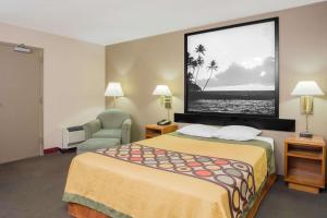 A bed or beds in a room at Super 8 by Wyndham Madison East