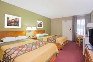 A bed or beds in a room at Super 8 by Wyndham Madison East