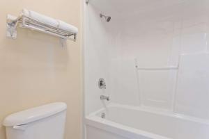 a white bathroom with a shower and a toilet at Super 8 by Wyndham Franklin Hwy 31 in Franklin