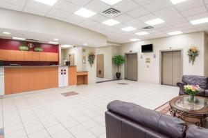 a lobby with a waiting area and a waiting room at Super 8 by Wyndham Mississauga in Mississauga