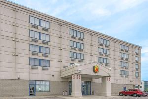 a building with a car parked in front of it at Super 8 by Wyndham Mississauga in Mississauga