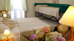 Postel nebo postele na pokoji v ubytování Hotel Villa Augustus