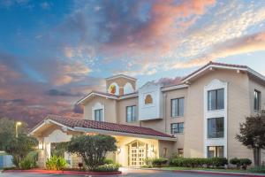 a church building with a sunset in the sky at Super 8 by Wyndham Austell/Six Flags in Austell