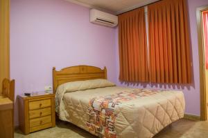 A bed or beds in a room at La Posada De Sancho