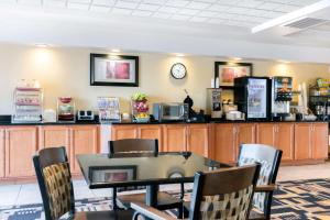 a dining room with a table and chairs and a counter at Wingate by Wyndham Dayton - Fairborn in Fairborn