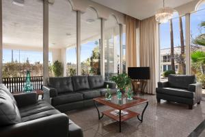 a living room with a couch and a table at Travelodge by Wyndham Bakersfield in Bakersfield