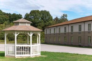 a white gazebo in front of a building at Super 8 by Wyndham Beaver Falls in Beaver Falls