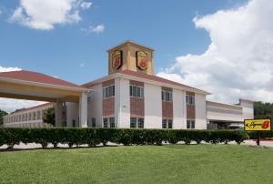 a building with a clock tower on top of it at Super 8 by Wyndham Rosenberg TX in Rosenberg