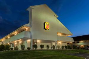 a fast food building with a pdq sign at night at Super 8 by Wyndham Strongsville/Cleveland in Strongsville