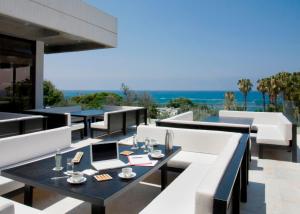 an outdoor patio with tables and a laptop on it at Almyra in Paphos