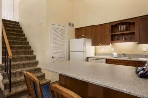 a kitchen with a counter top and a staircase at Affordable Suites of America Grand Rapids in Grand Rapids