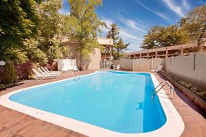 a swimming pool in the backyard of a house at Knights Inn Traverse City in Traverse City