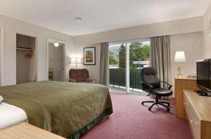 a hotel room with a bed and a television at Travelodge by Wyndham Hope in Hope