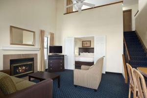 a hotel room with a bed and a fireplace at Hawthorn Suites - Fort Wayne in Fort Wayne