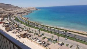 a view of the beach from the balcony of a resort at Apartment in Porto Sokhna Pyramids for Families in Ain Sokhna