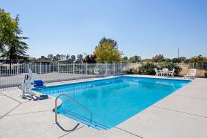 una piscina blu con una recinzione intorno di Super 8 by Wyndham Oroville a Oroville