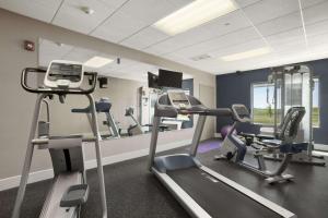 a gym with tread machines and a mirror at Wingate by Wyndham - Bismarck in Bismarck