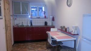 a small kitchen with a table and a sink at Rostock Übernachtung in Rostock