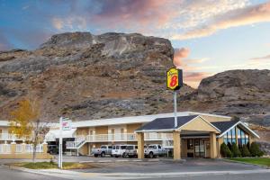 a hotel with a sign in front of a mountain at Super 8 by Wyndham Wendover in Wendover