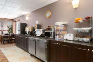 a kitchen filled with appliances and a counter top at Travelodge by Wyndham Meadow Lake in Meadow Lake