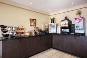 a coffee bar in a hotel room with a counter at Travelodge by Wyndham Kapuskasing in Kapuskasing