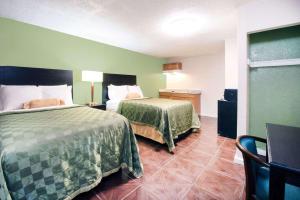 Postel nebo postele na pokoji v ubytování Executive Inn & Kitchenette Suites-Eagle Pass