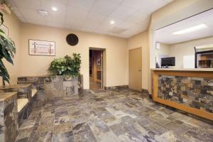 a lobby of a hospital with a tile floor at Central Suite Hotel in Lloydminster